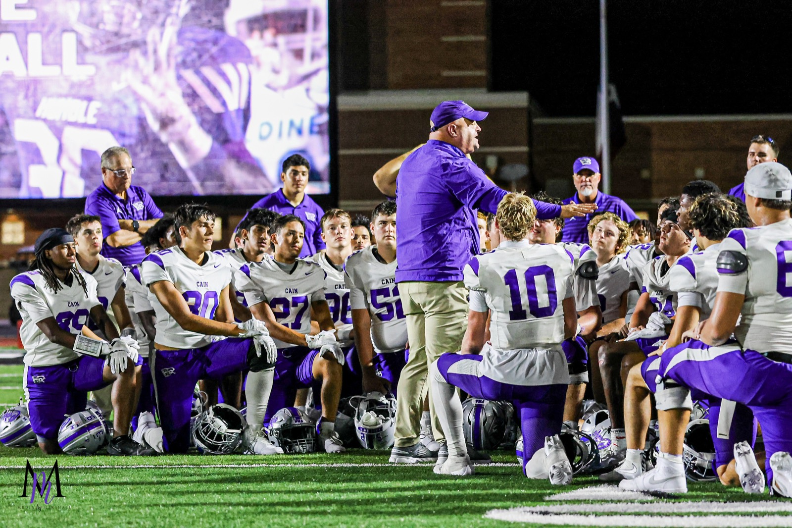 Head coach James Clancy addresses the Klein Cain Hurricanes in the postgame huddle on the Turner Stadium turf