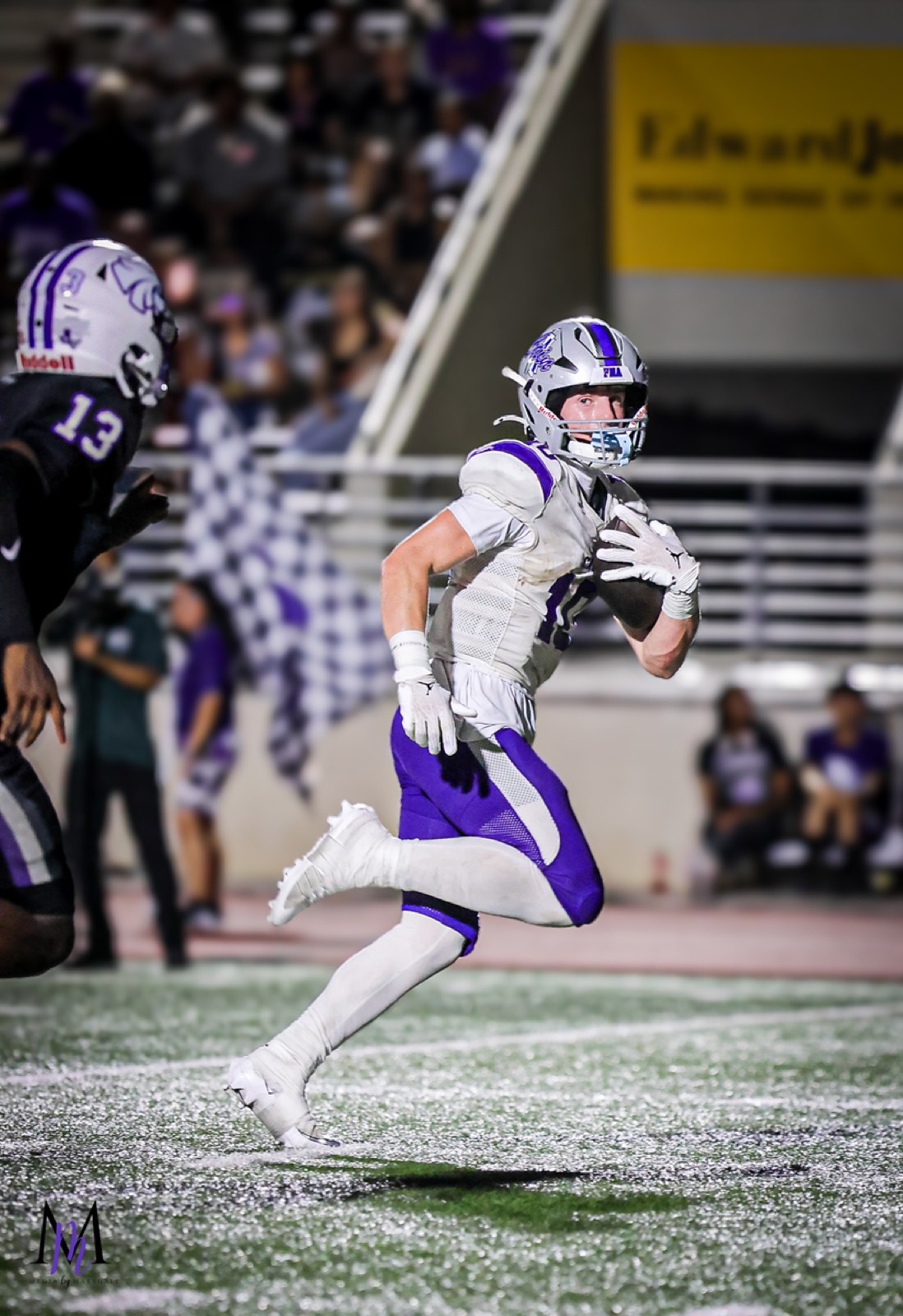 Senior wide receiver Cooper Karns turns upfield after a reception along the sideline