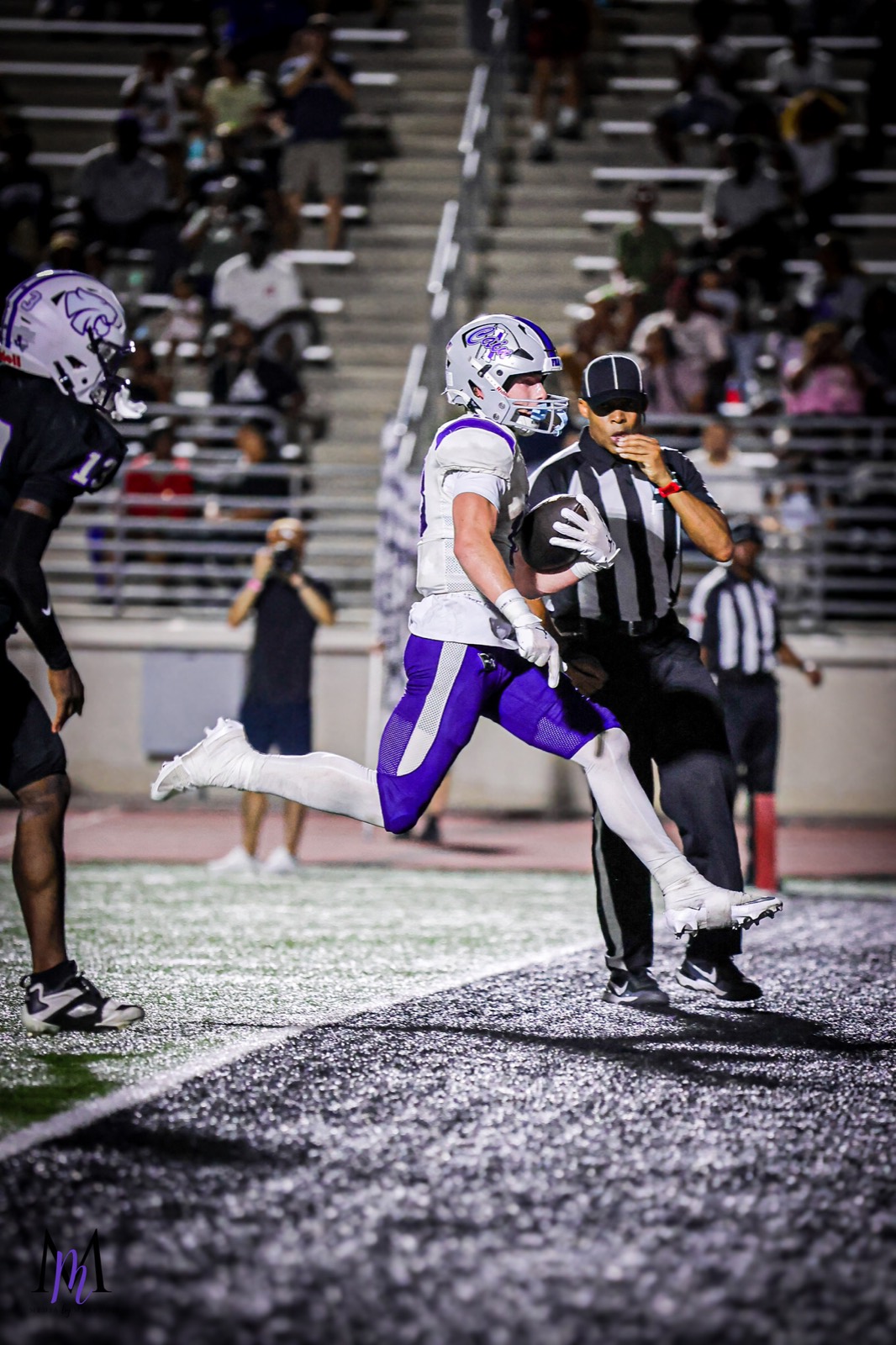 Senior wide receiver Cooper Karns strides across the goal line into the end zone for a touchdown