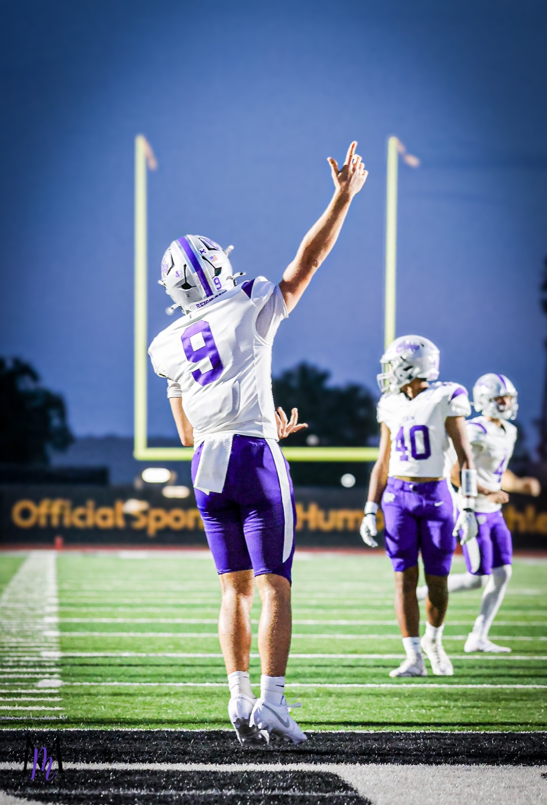 Junior quarterback Jace Hanks points to the sky in celebration under the Turner Stadium uprights with senior wide receiver Cooper Karns