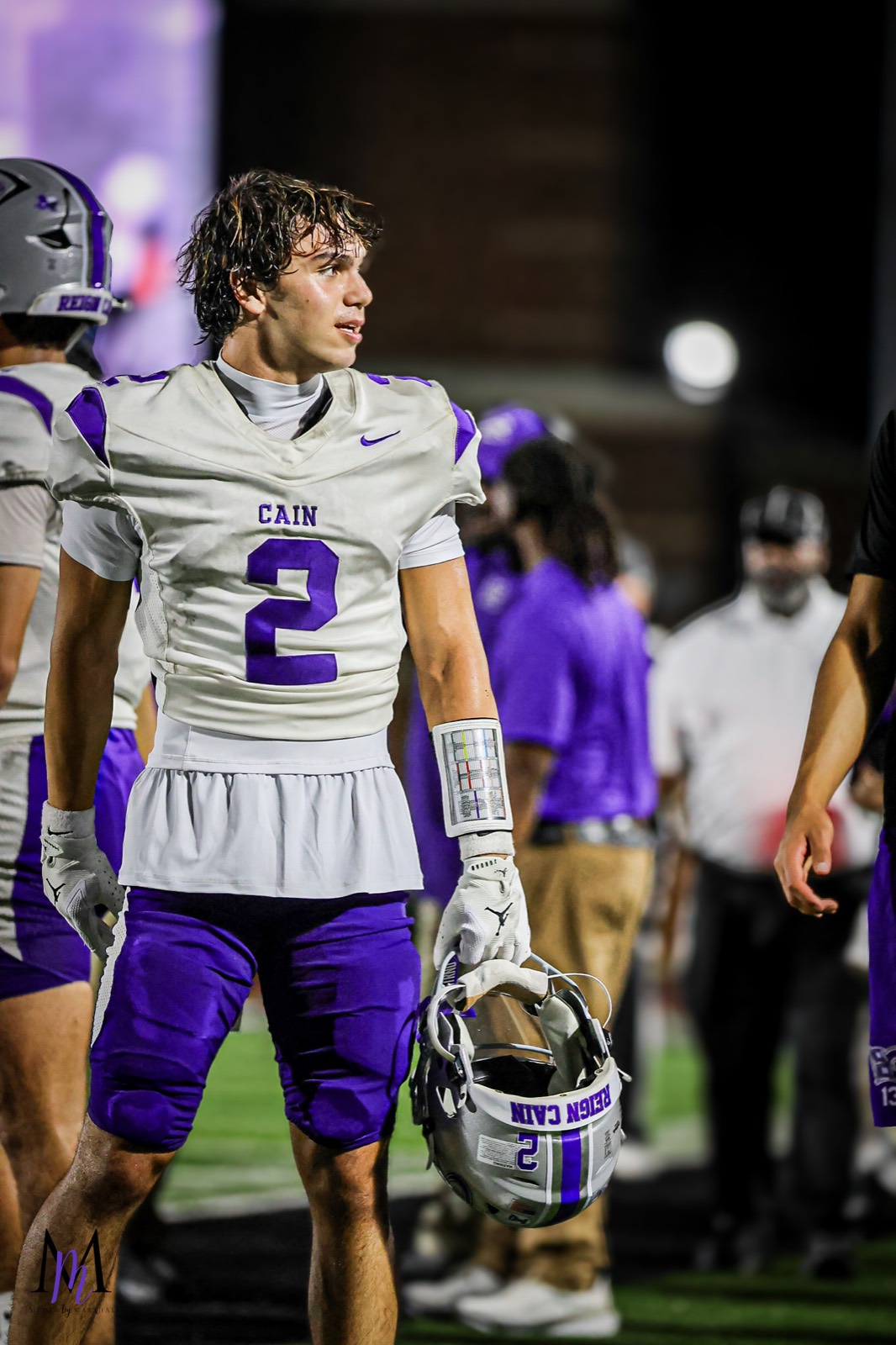 Senior defensive back Michael Elhindi stands on the field with helmet in hand