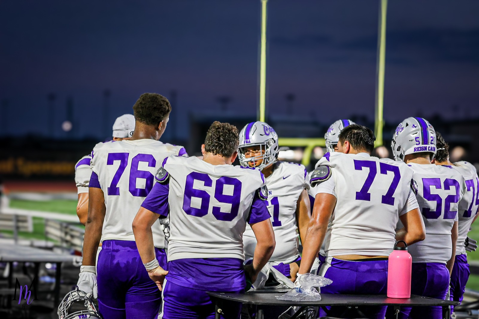 The Klein Cain offensive line gathers around the hydration table during a break in play