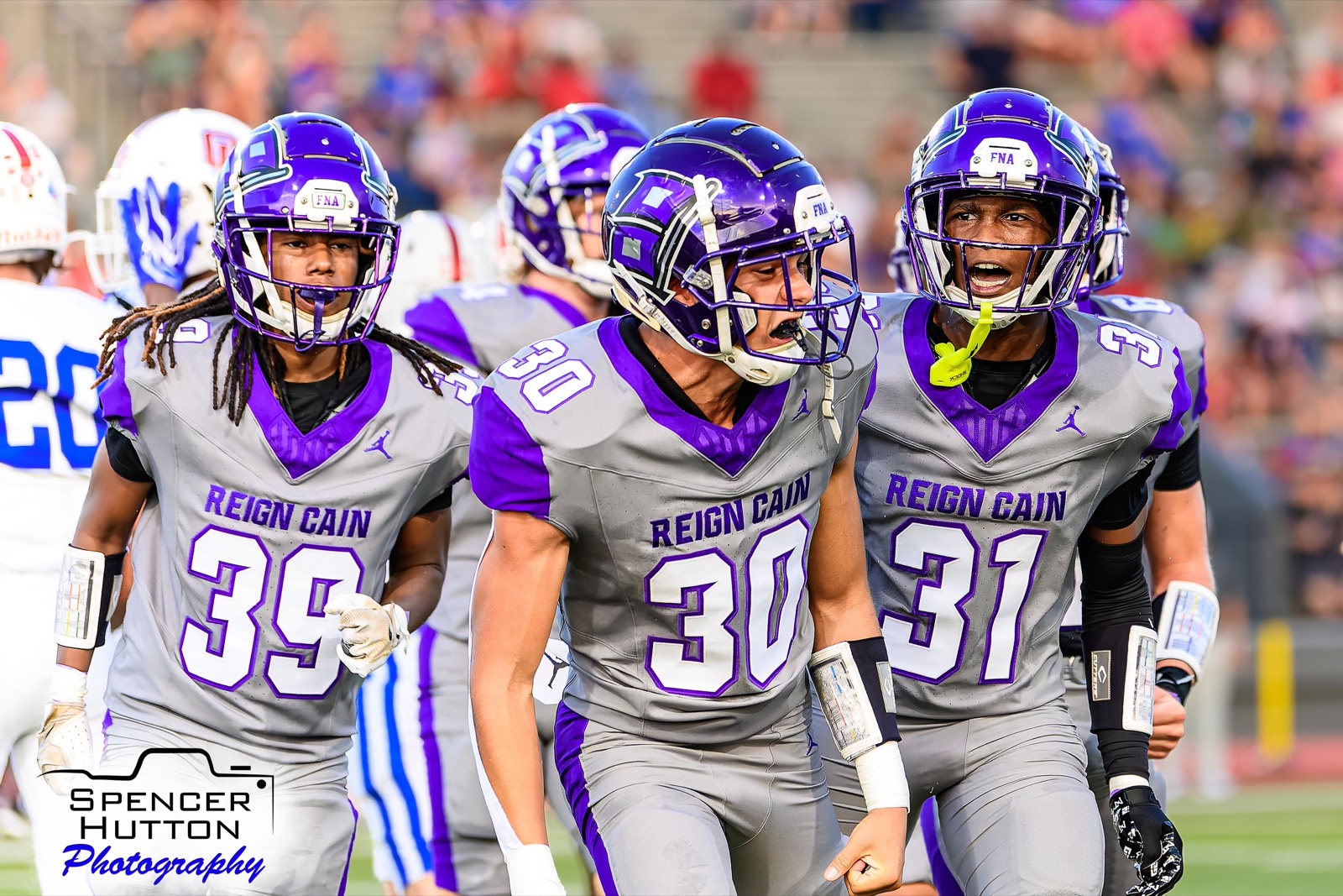 Junior linebacker Jhonny Vilchez, junior defensive back Colby Braxton, and senior defensive back Cayden Strong celebrate a stop