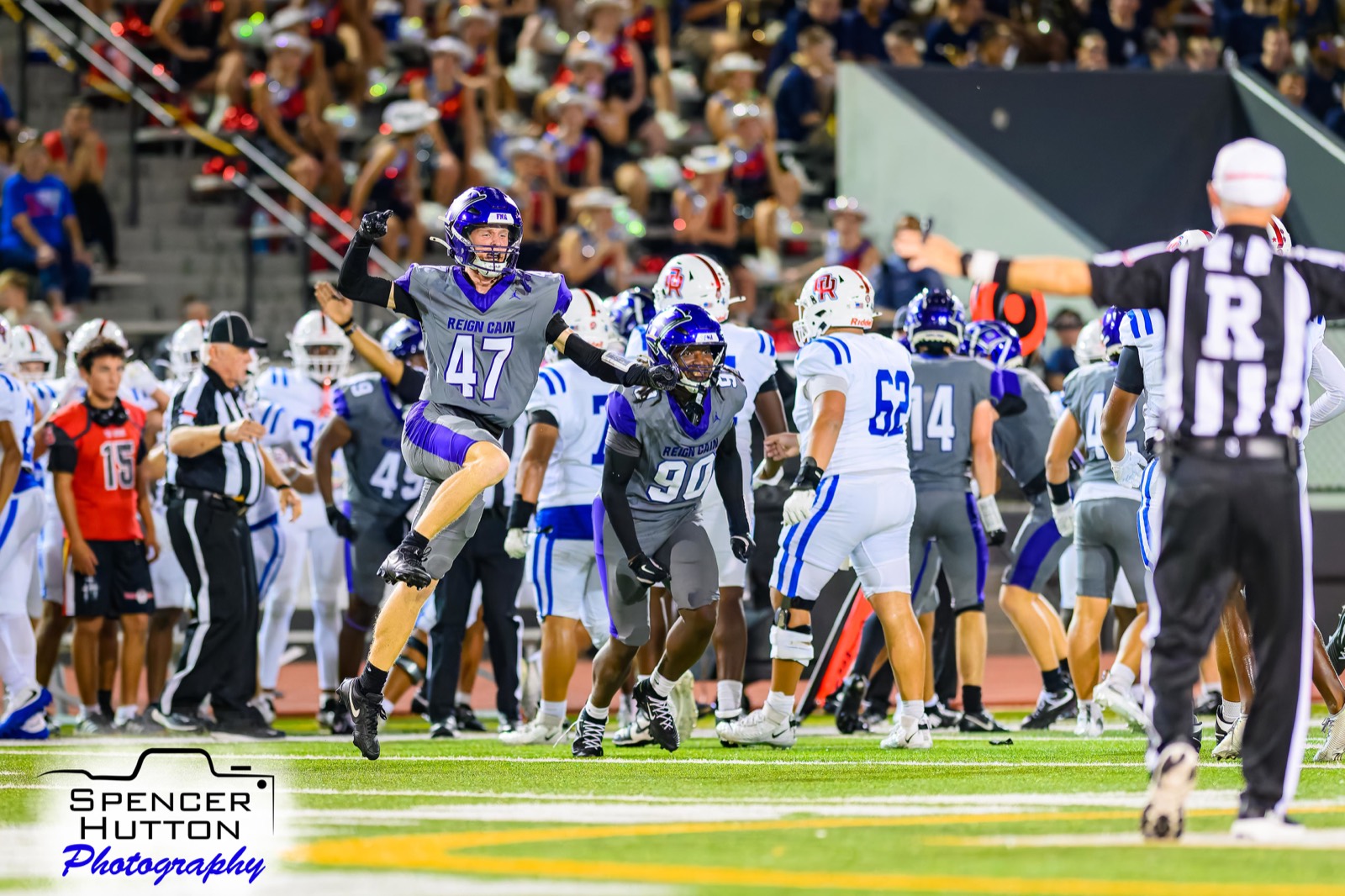 Junior safety Easton Mizell leaps in celebration alongside senior defensive lineman Kenyon White