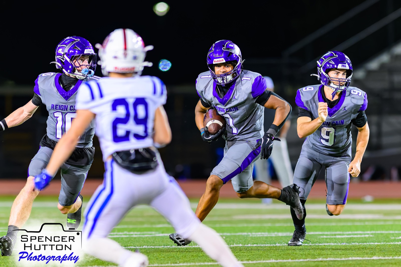 Junior running back Earl Oguinn Jr. charges upfield behind blocks from Jace Hanks and Cooper Karns