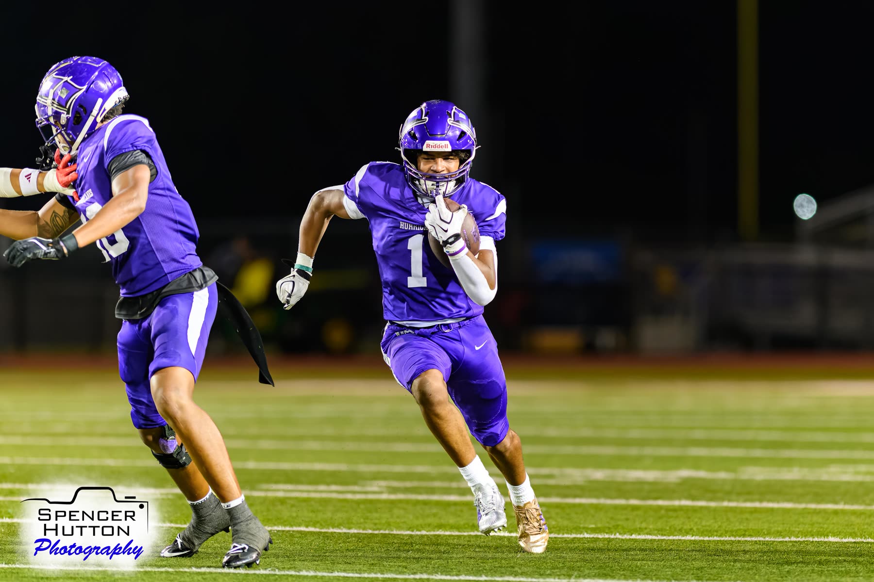 Junior running back Earl Oguinn Jr. bursts downfield behind a lead block from Cooper Karns