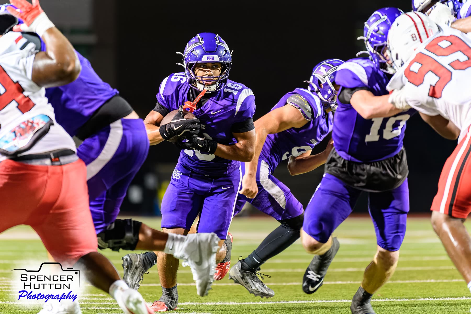 Senior running back Eyan Johnson cuts through the interior defense behind lead blocking