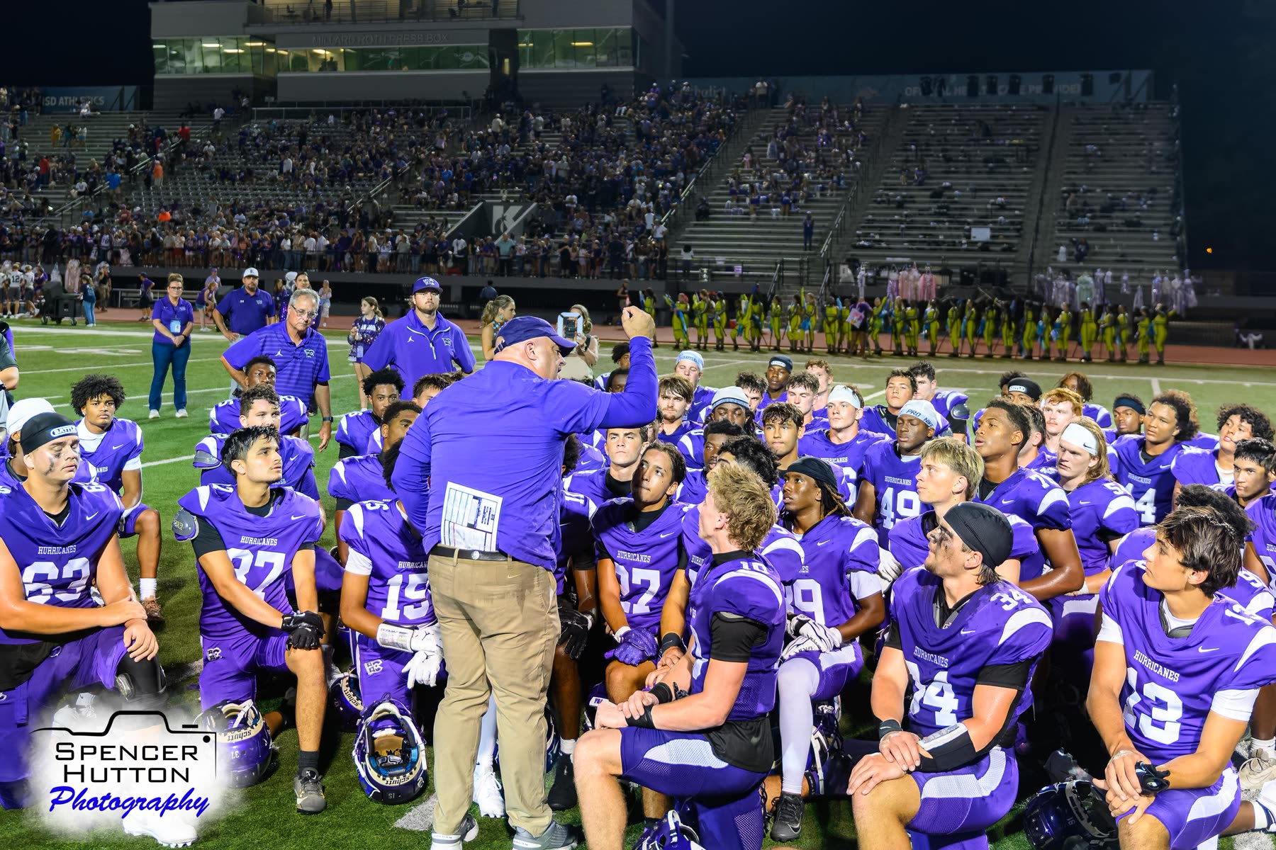 Head coach James Clancy speaks to the Hurricanes during the postgame team huddle