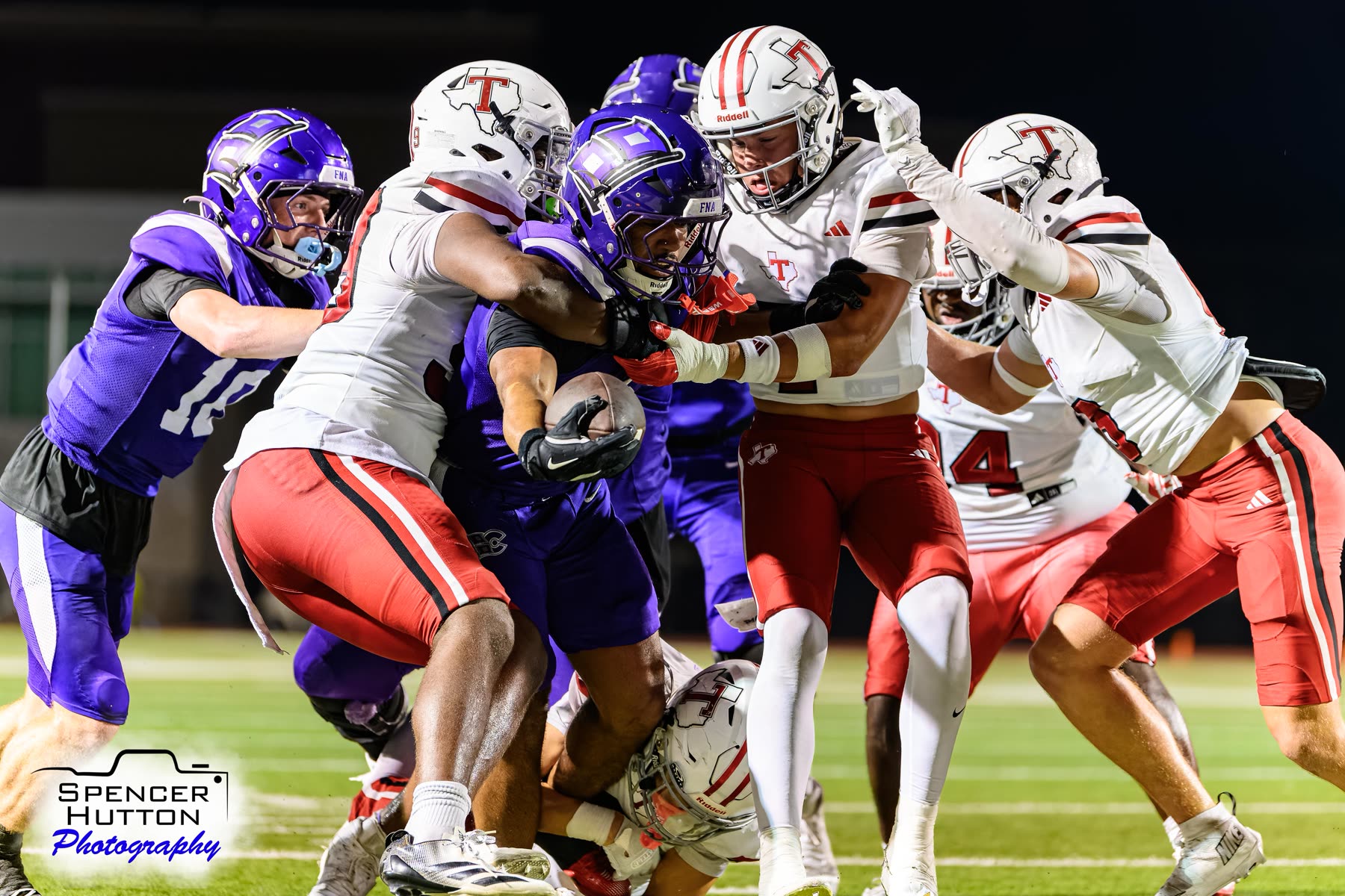 Senior running back Eyan Johnson drives through multiple Tomball defenders with Deaunte Barr assisting